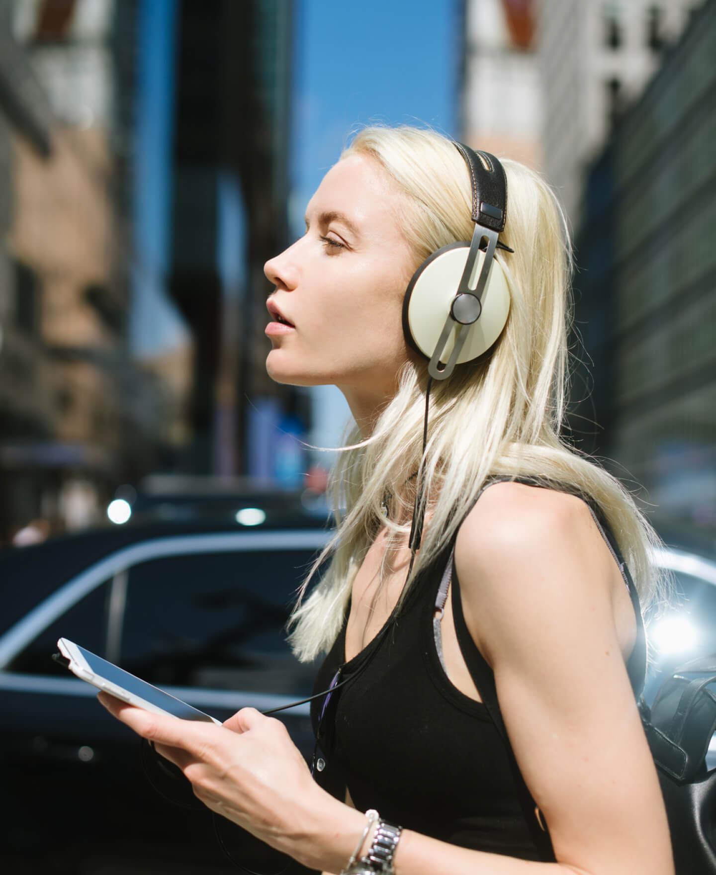 Girl with phone in hand and headphone on head