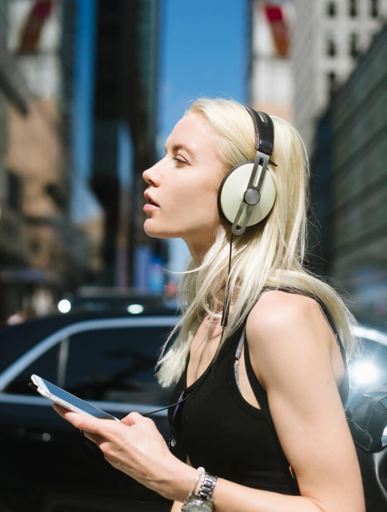 Girl with phone in hand and headphone on head